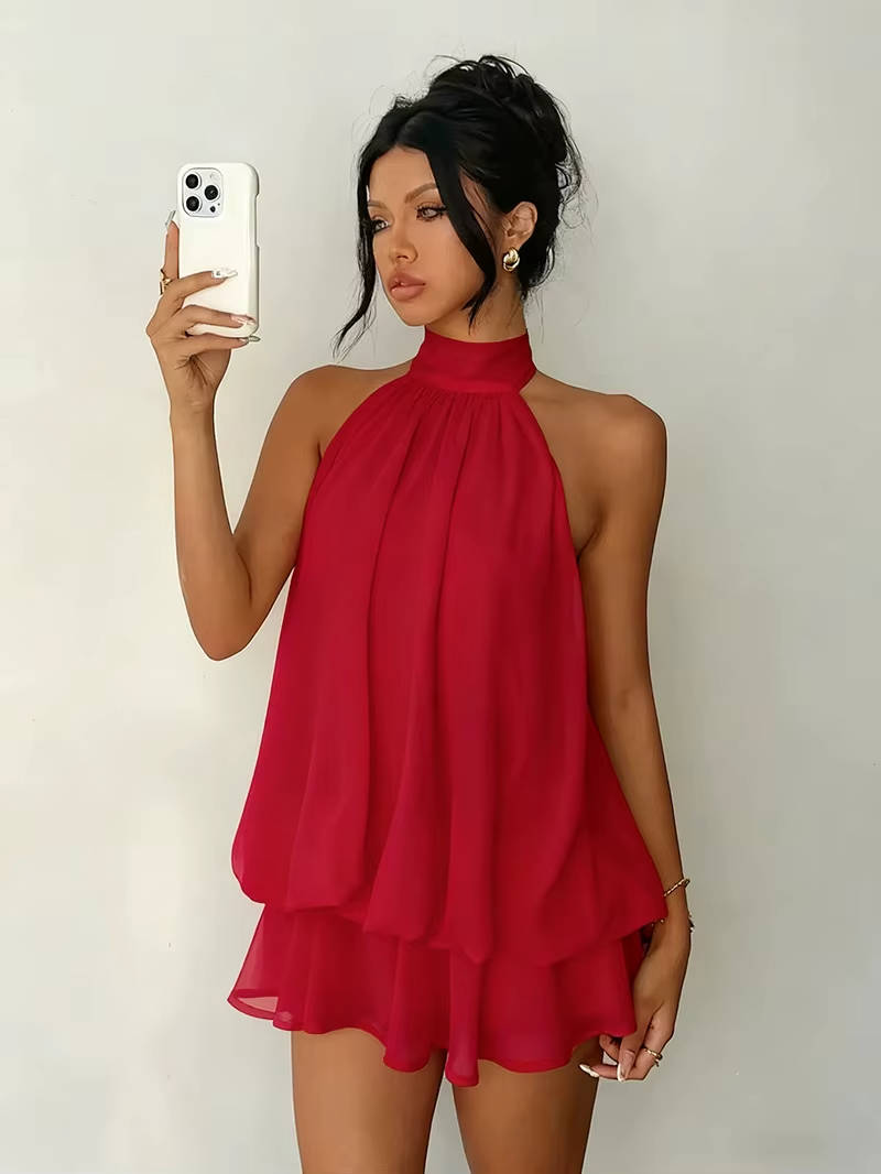 Sleek women's halter mini dress, ideal for parties, boasting an open back and ruffle details.