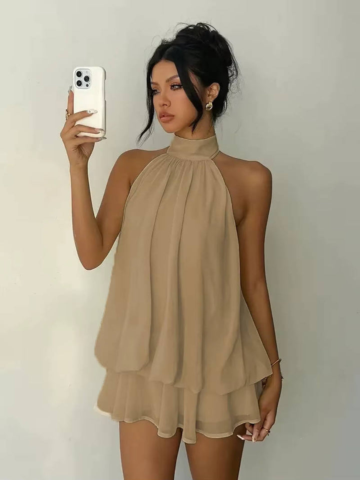 Modern women's party halter dress, sleeveless with a distinctive ruffle hem.