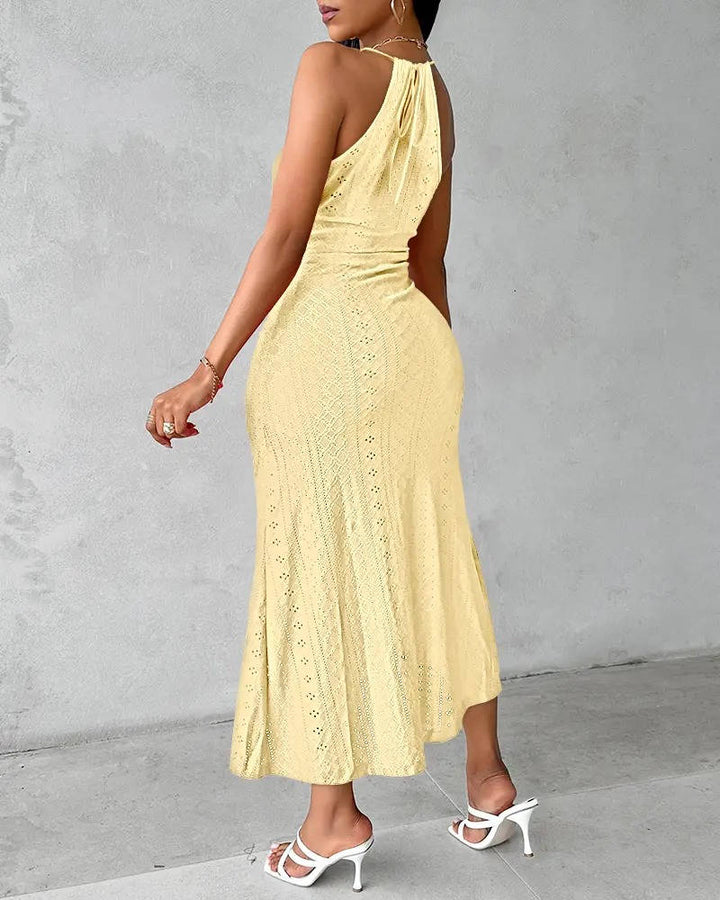Detail shot of the high slit on an elegant women's halter neck A-line maxi gown, perfect for evening wear.