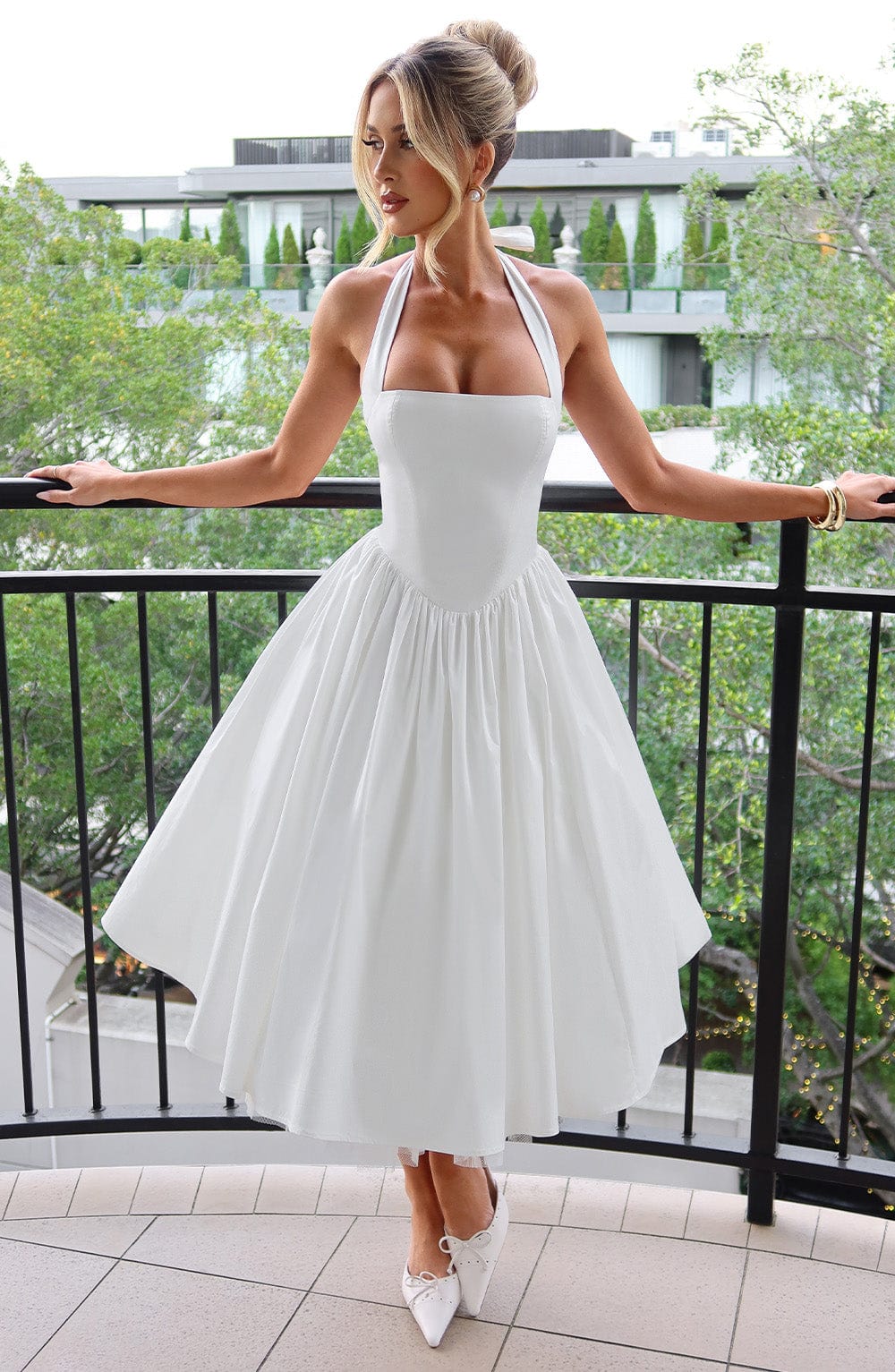 Elegant women's halter neck midi cocktail dress, perfect for sophisticated special occasions.
