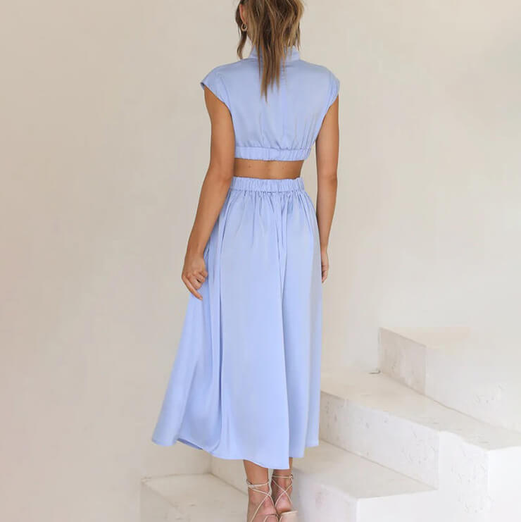Flowing women's midi dress, halter neck style with a high side slit, perfect for evenings or casual wear.