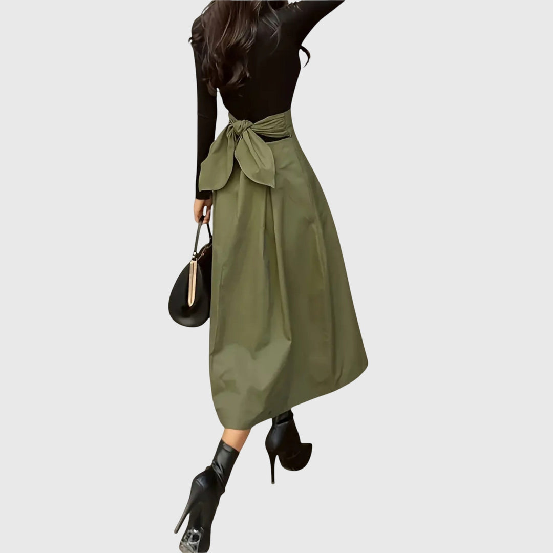 Chic green A-line midi skirt for women, featuring a high waist and pleats, ideal for elegant casual or office outfits.
