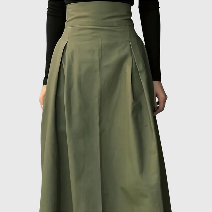 Stylish pleated green midi skirt, high-waisted A-line cut for women, offering a modest and elegant look for summer/spring.