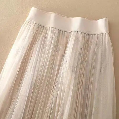 Graceful pleated midi skirt for women, high-waisted cut, a key piece in elegant womens clothing.