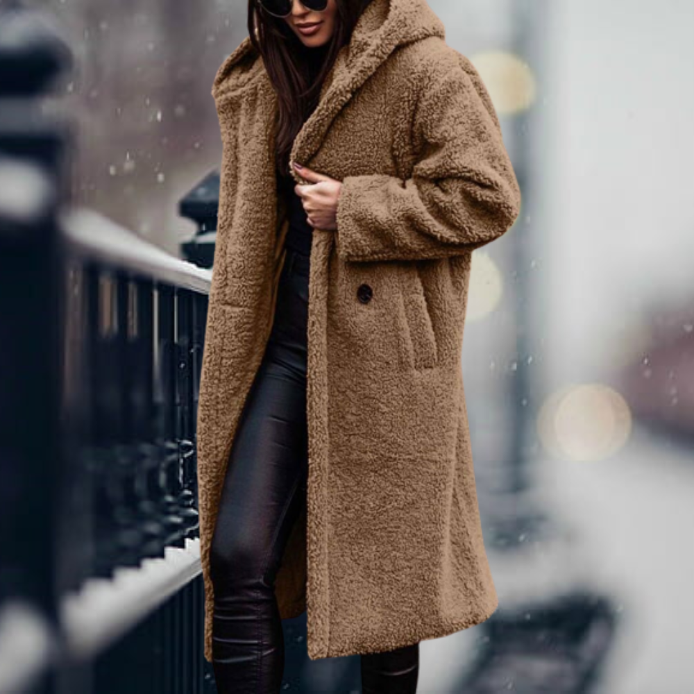Elegant women's winter outerwear: a cozy hooded jacket designed for warmth and fashion in cold weather.