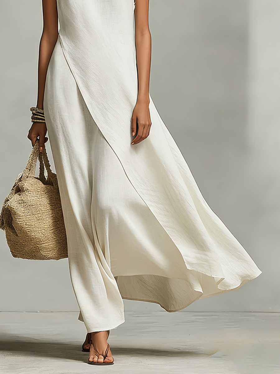Women's sleeveless ivory maxi dress, offering a flowy asymmetric hem for a comfortable, elegant look.