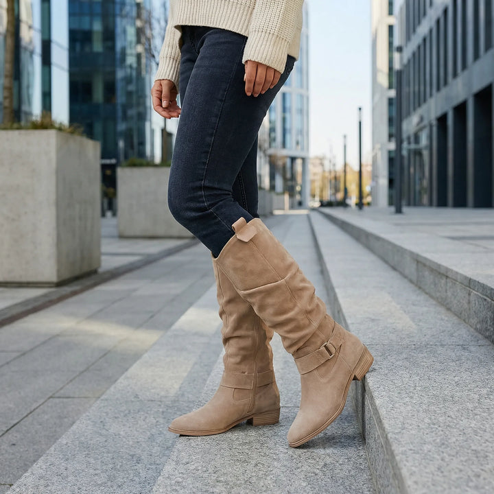 Elegant women's knee-high boots with low heel, side zipper & delicate bow detail for stylish fall fashion.