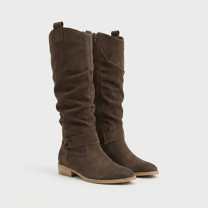 Versatile women's knee-high boots: comfortable, stylish, low heel, & bow detail. Great for elegant winter wear.