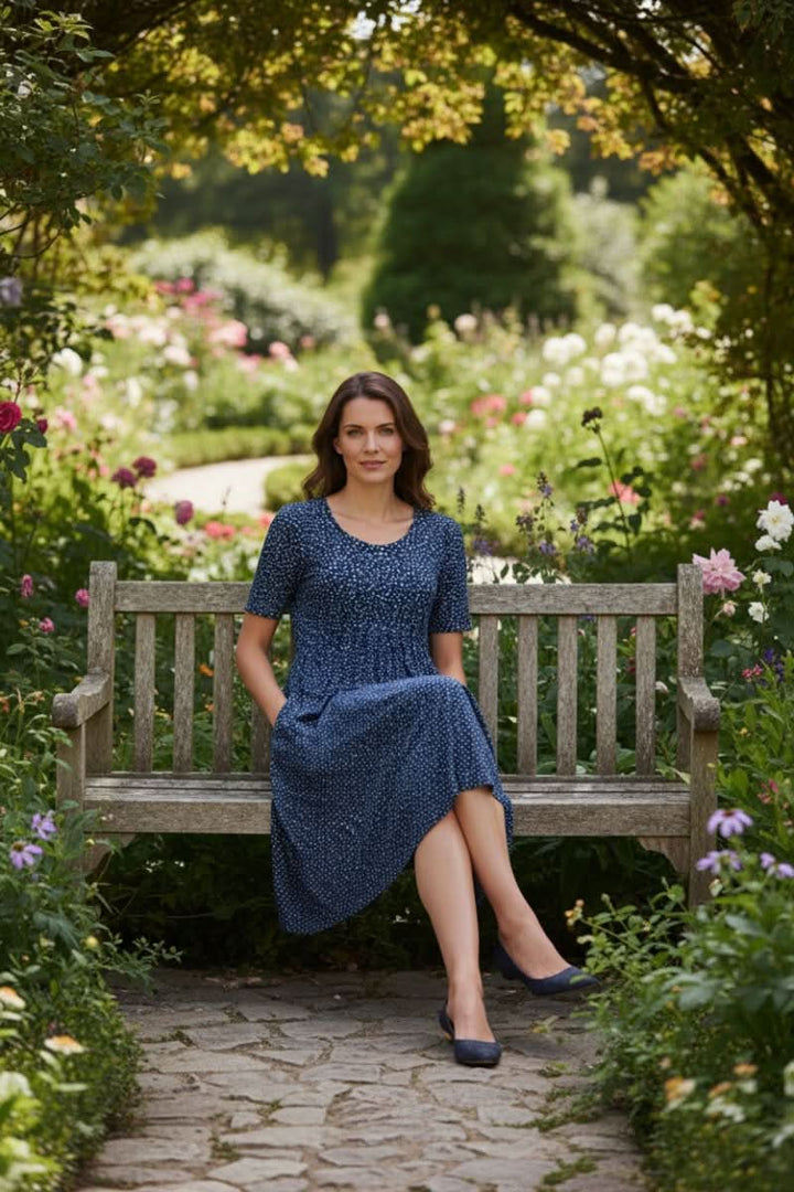 Beautiful floral pattern on a knee-length women's summer dress with convenient side pockets.