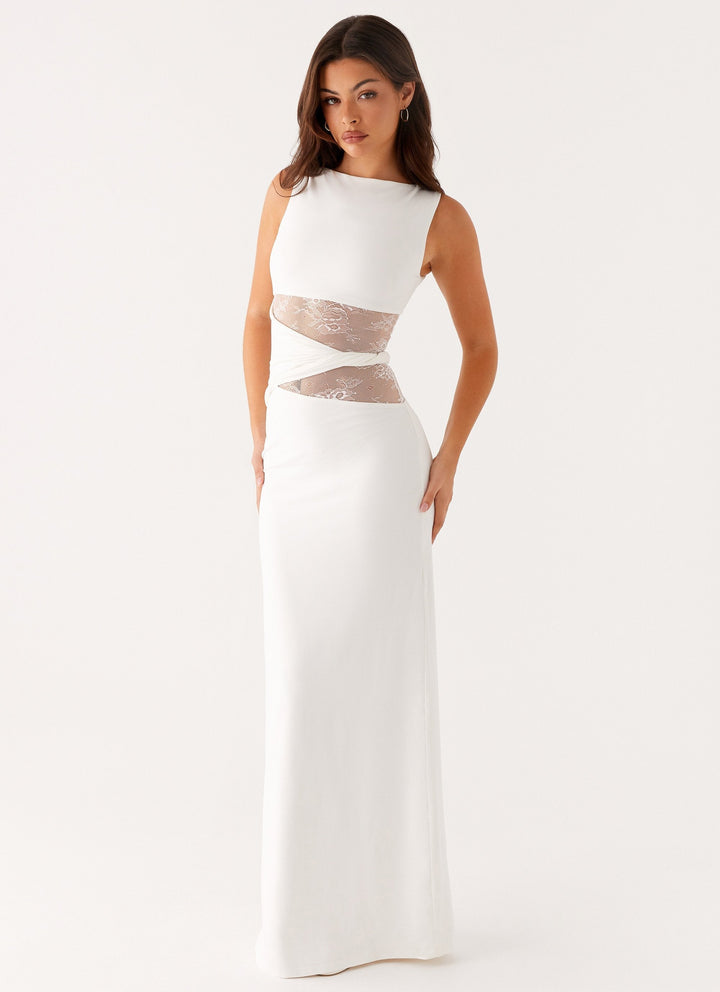 Fashionable women's long party dress, featuring a boat neck, sleeveless design, and intricate lace cut-outs.