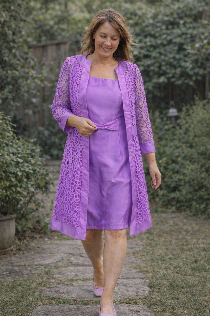 Sophisticated women's lace midi dress paired with a stylish jacket for formal events.