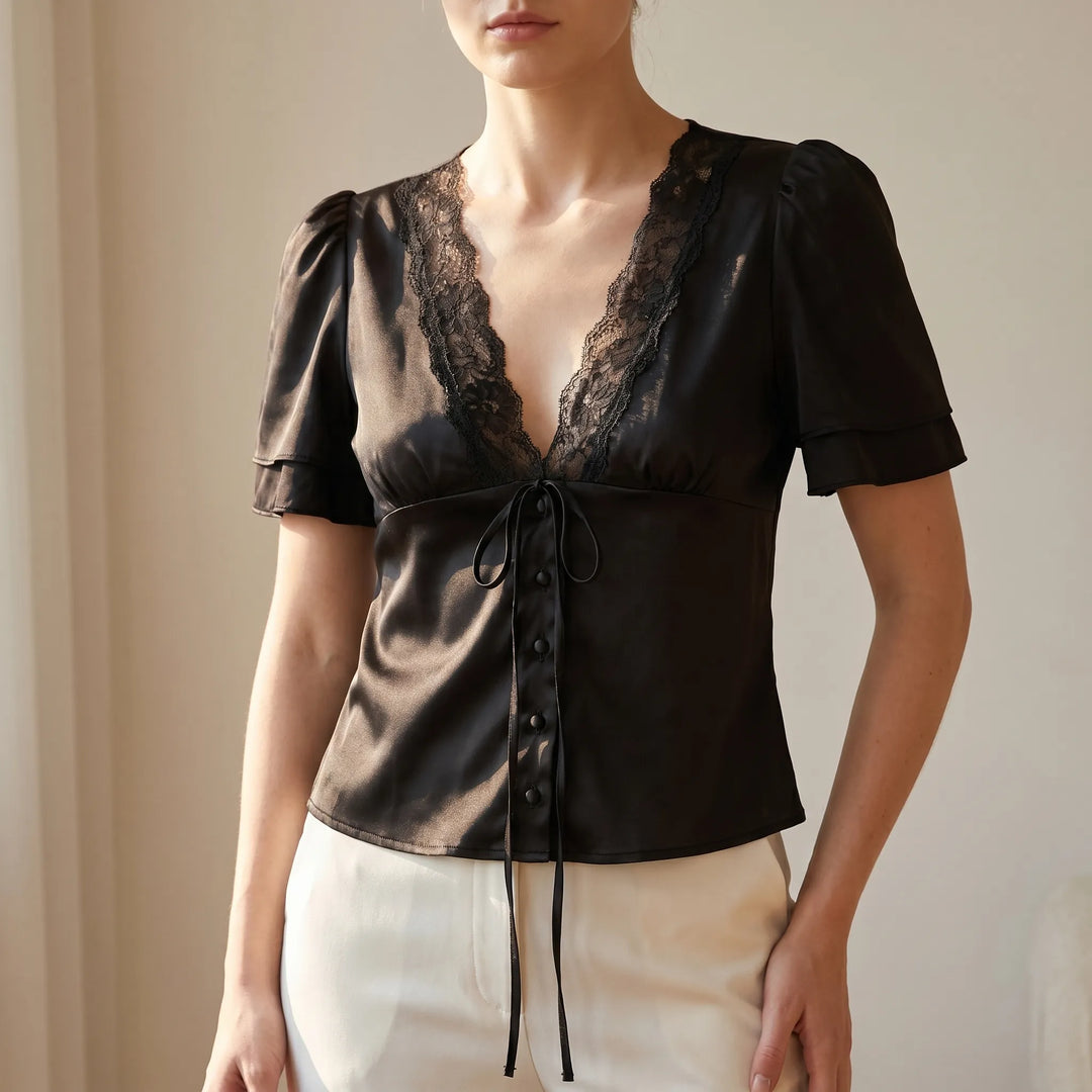 Elegant women's lace-trim V-neck blouse with short flutter sleeves, perfect for versatile day-to-night style.