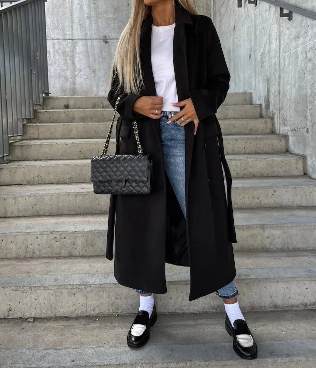 Elegant women's long trench coat, a tailored & structured outerwear essential for fall and winter fashion.