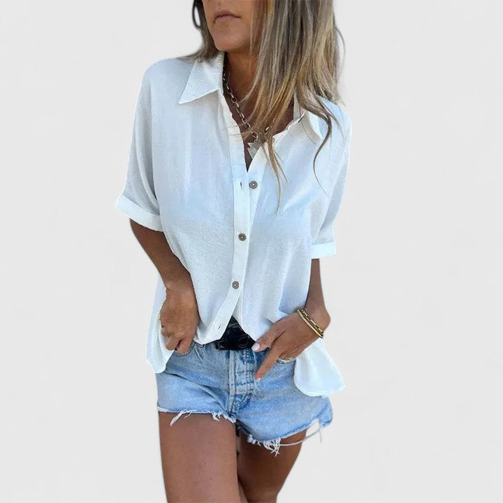 Chic button-down women's blouse with long sleeves, offering timeless fashion for both formal and casual occasions.
