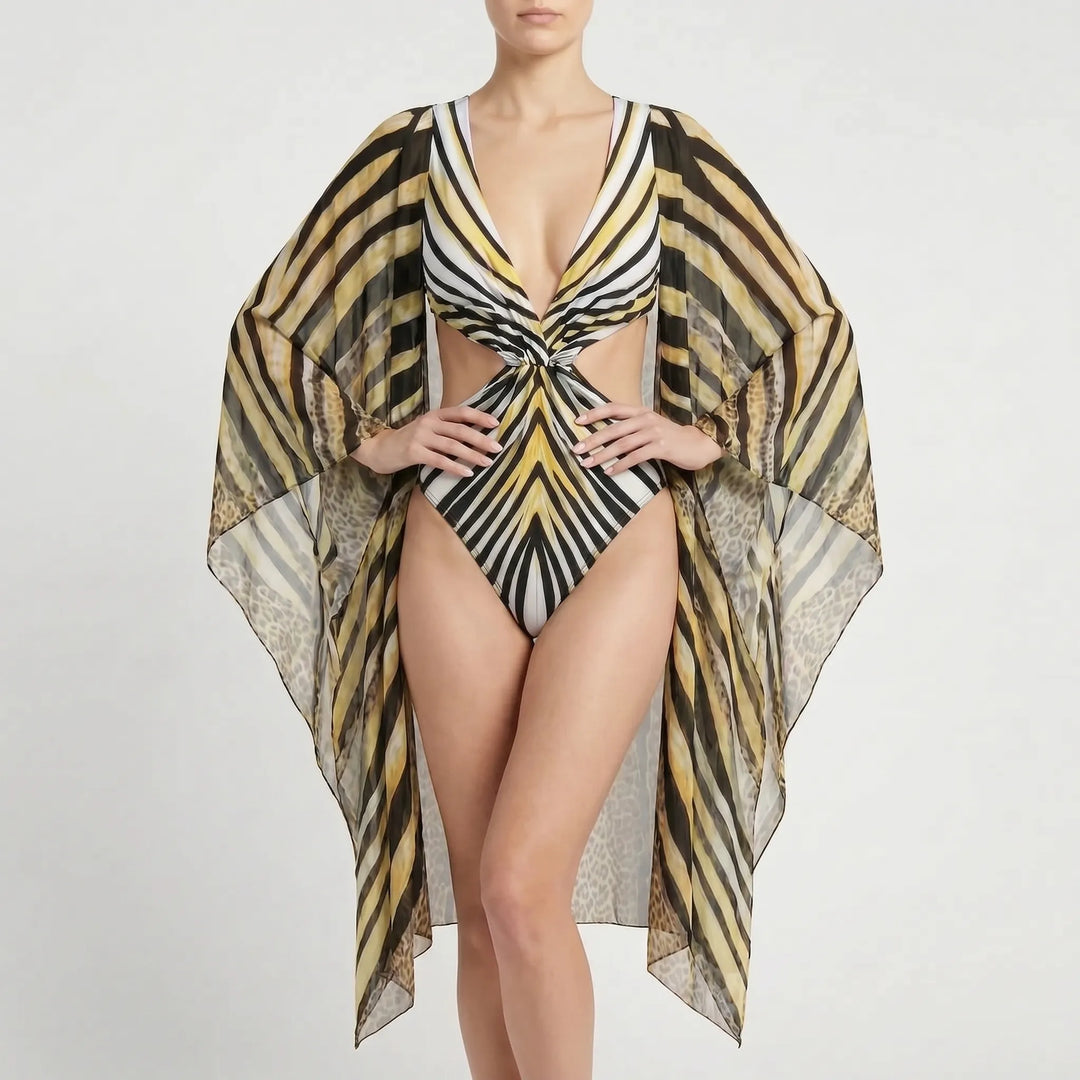 Vibrant abstract print long-sleeve monokini with stylish cutouts. Women's elegant one-piece for resort.