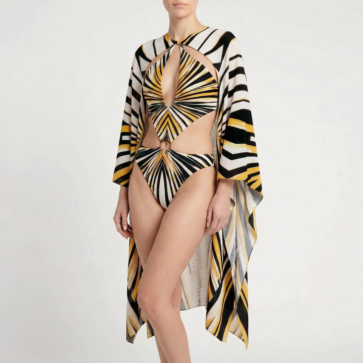 Chic women's long-sleeve monokini with trendy cutouts & abstract print. One-piece swimwear for resort beachwear.