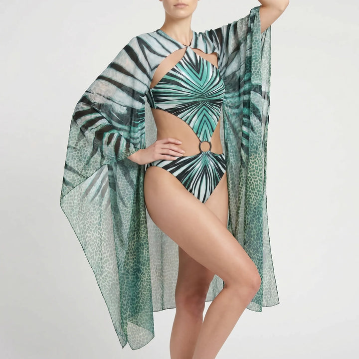 Resort-ready long-sleeve monokini with strategic cutouts. Women's elegant one-piece swimsuit for vacation.