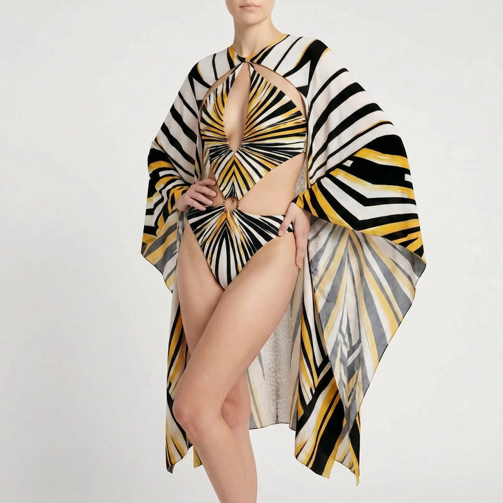 Woman modeling elegant long-sleeve cutout monokini. Perfect for a chic resort beach vacation or pool party.