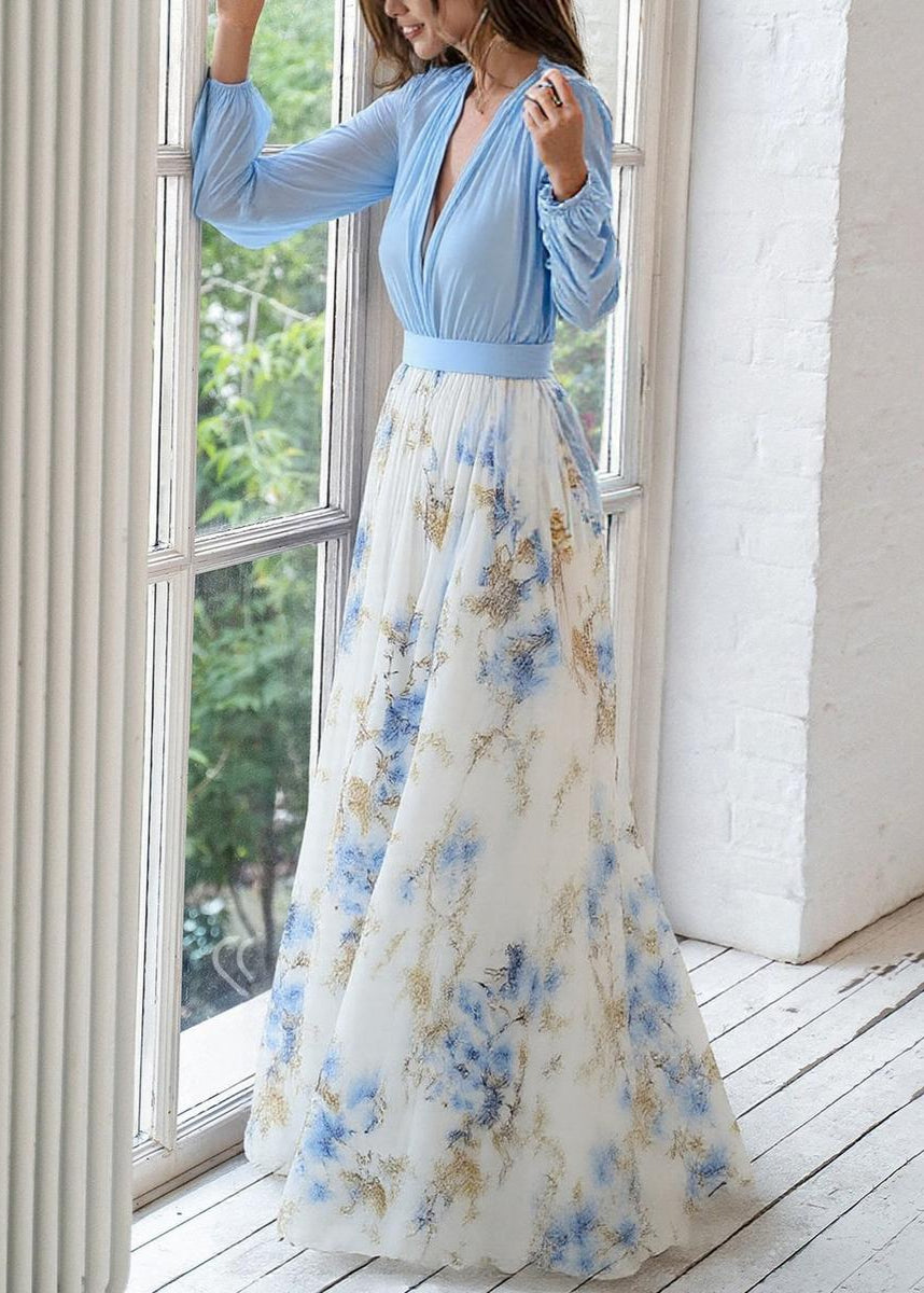 Flowing light blue floral print maxi dress for women, featuring long sleeves and a stylish deep V-neck.