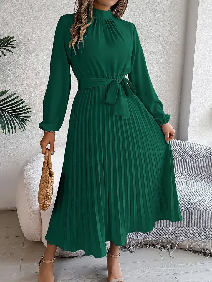 Stylish women's pleated midi dress, long sleeves, with an elegant cinched belt. Great for fall fashion.