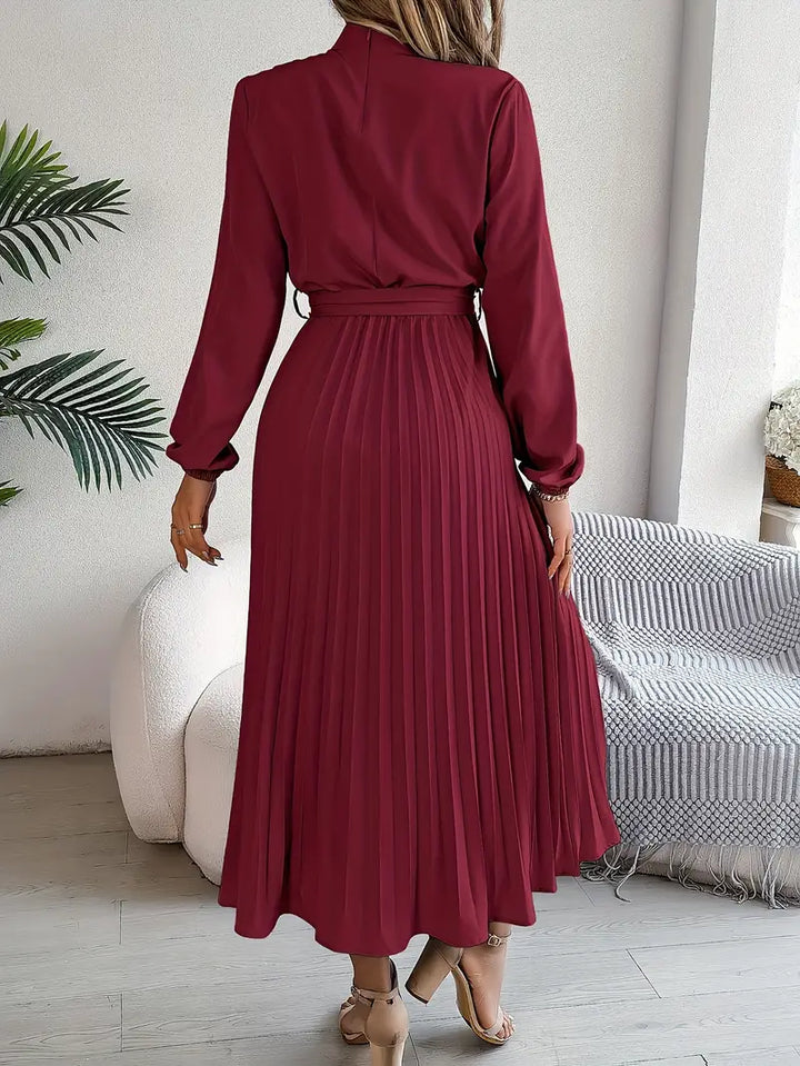 Women's elegant long sleeve midi dress featuring a sophisticated pleated design & a classic belted style.