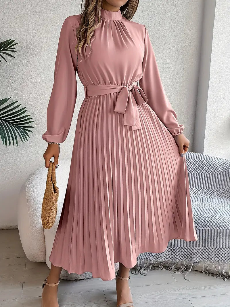 Graceful women's pleated midi dress, long sleeve, with an elegant belt, embodying classic fall/spring style.