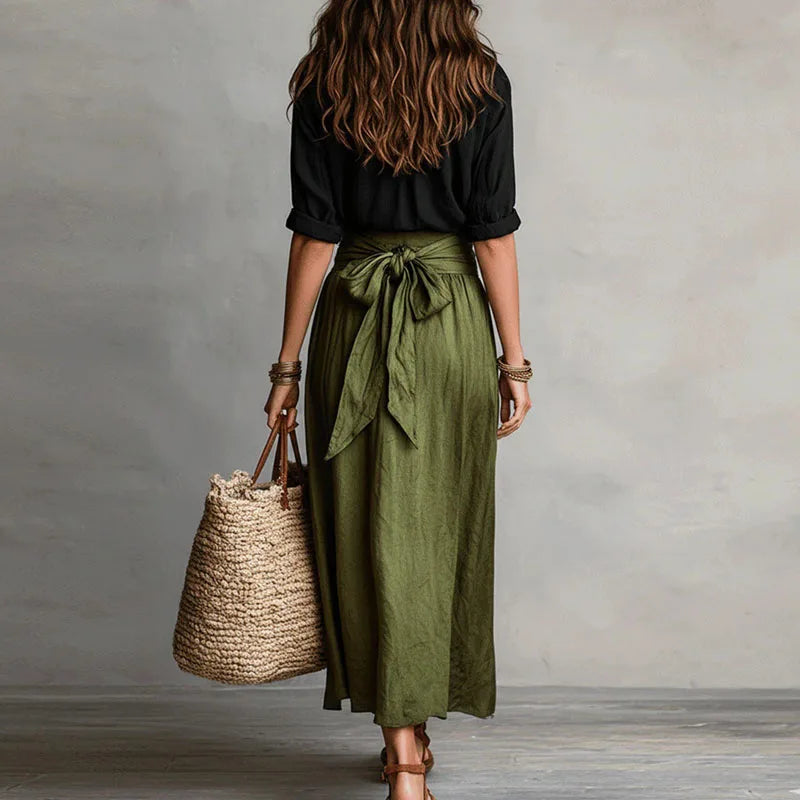 Fashionable women's long sleeve skirt suit with a button-down top and tie-waist skirt for elegant wear.