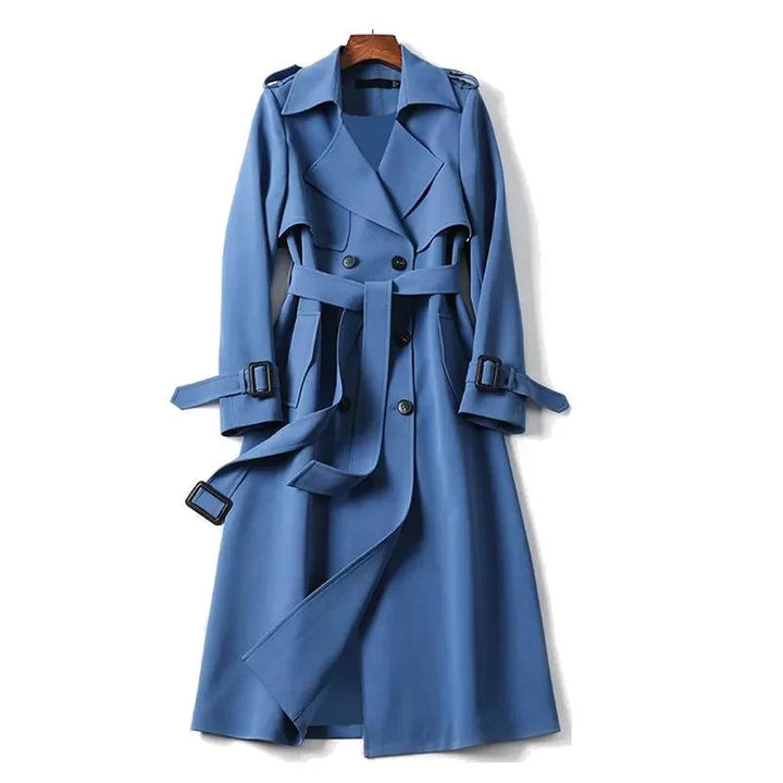 Elegant women's long trenchcoat with a tie belt, double-breasted front, and structured collar for office wear.