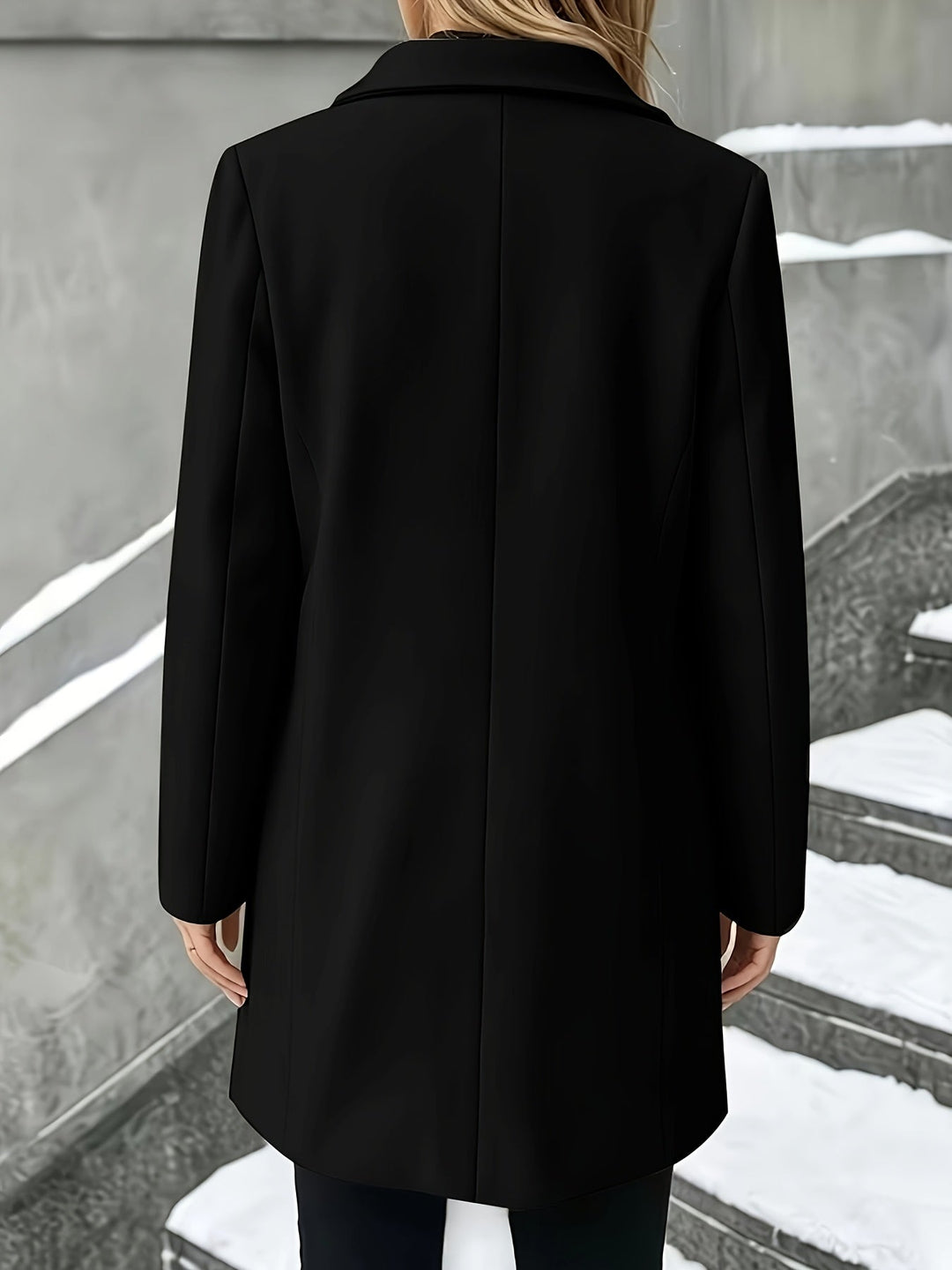 Chic women's longline coat, elegant tailored design, features a prominent notch collar. Winter essential.