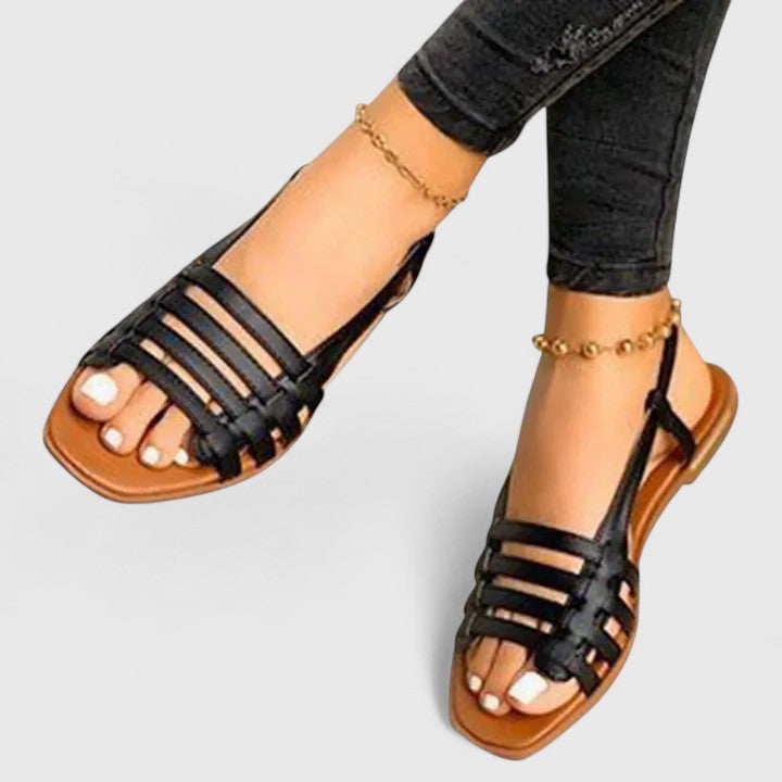 Stylish women's metallic flat sandals with intricate woven straps, open toe, and secure slingback for versatile summer wear.