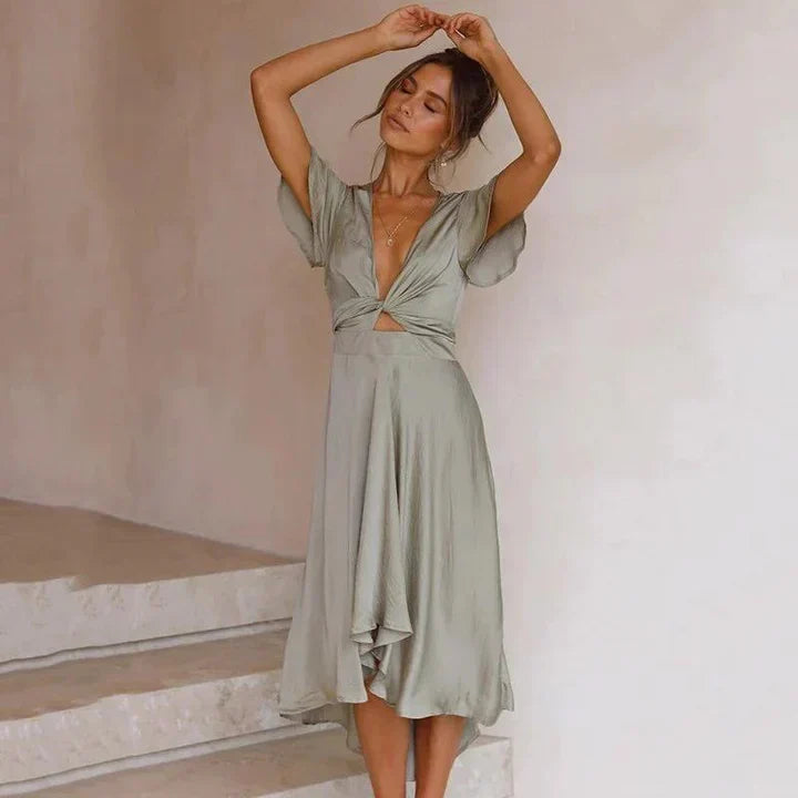 Flowy women's V-neck midi dress, tie front detail & flutter sleeves. Ideal for wedding guests & formal events.