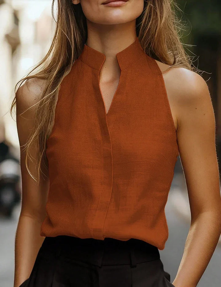Elegant women's mock neck sleeveless blouse, perfect for warm weather and summer fashion. Chic and versatile.