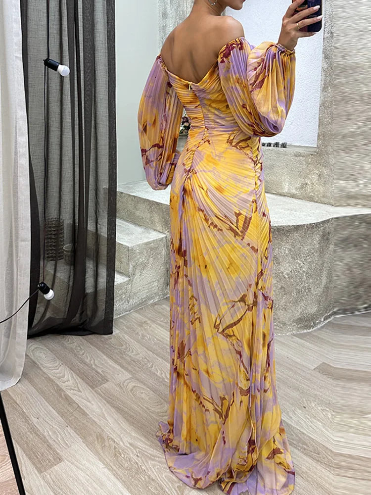 Stylish women's off-shoulder maxi dress featuring a vibrant watercolor print and elegant high slit, perfect for guests.
