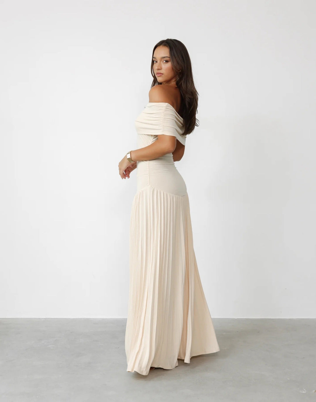 Sophisticated navy off-shoulder pleated maxi dress. Perfect formal evening gown for women.