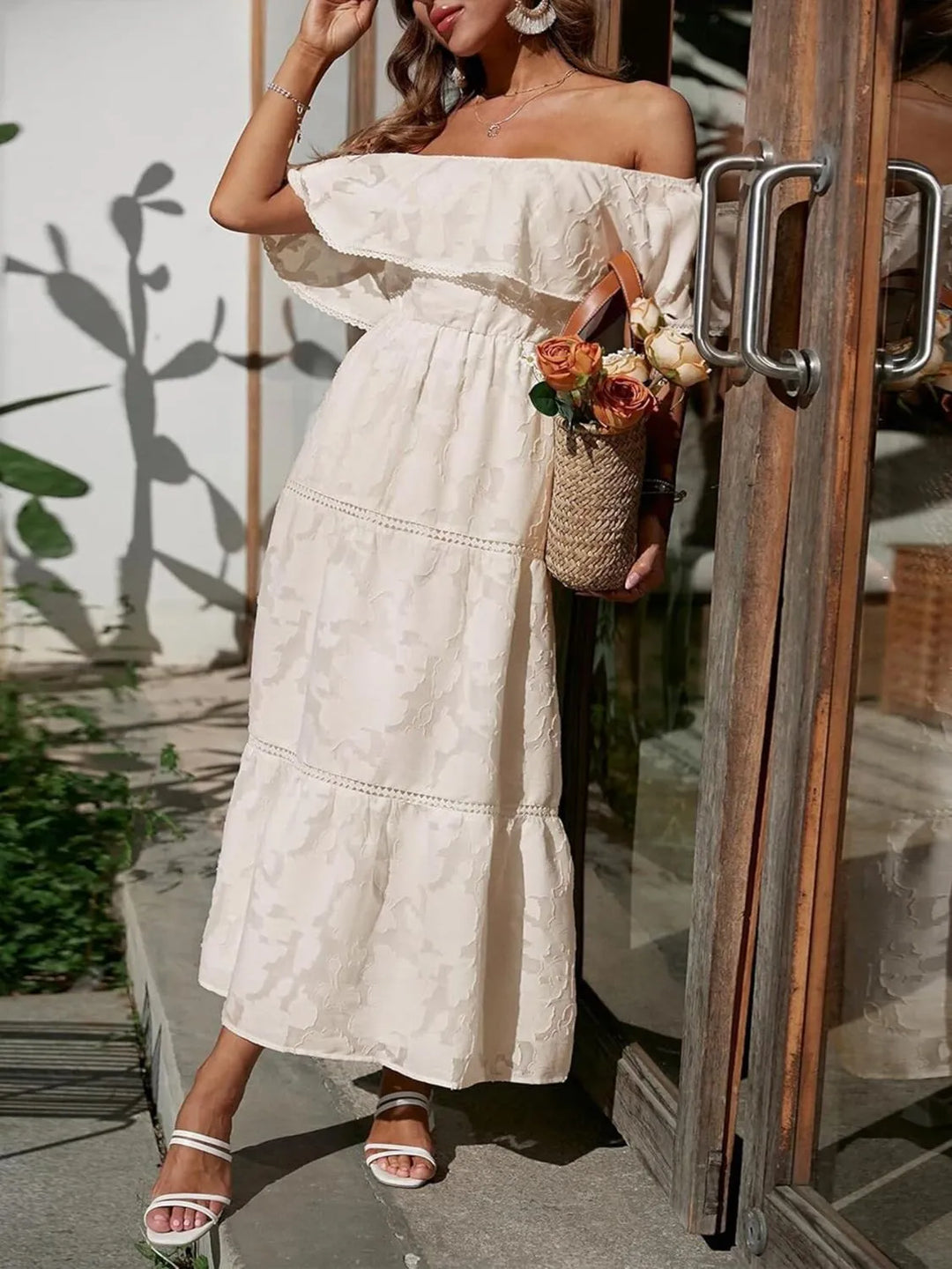 Luxurious fabric detail on the elegant off-shoulder ruffle maxi dress with delicate lace trim.