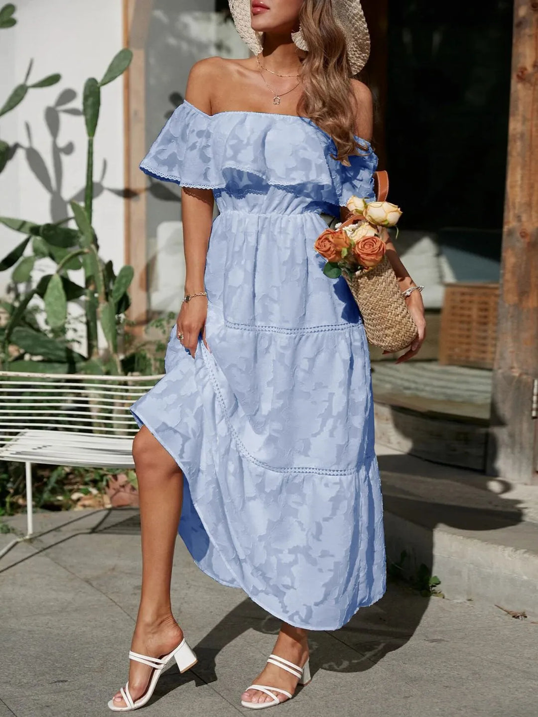 Detailed shot of the elegant tiered skirt and lace trim on the off-shoulder ruffle maxi dress.