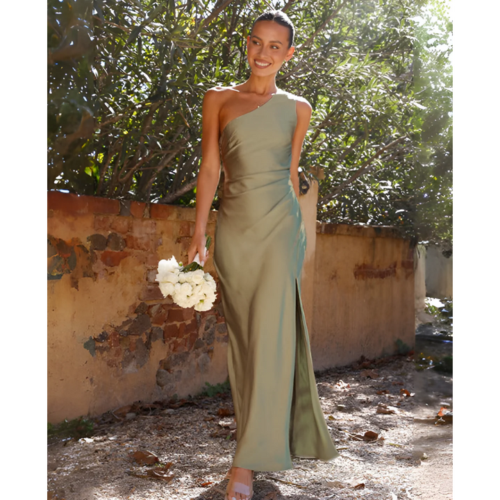 Elegant women's one-shoulder green maxi dress with a sophisticated side slit, perfect for formal evening events.