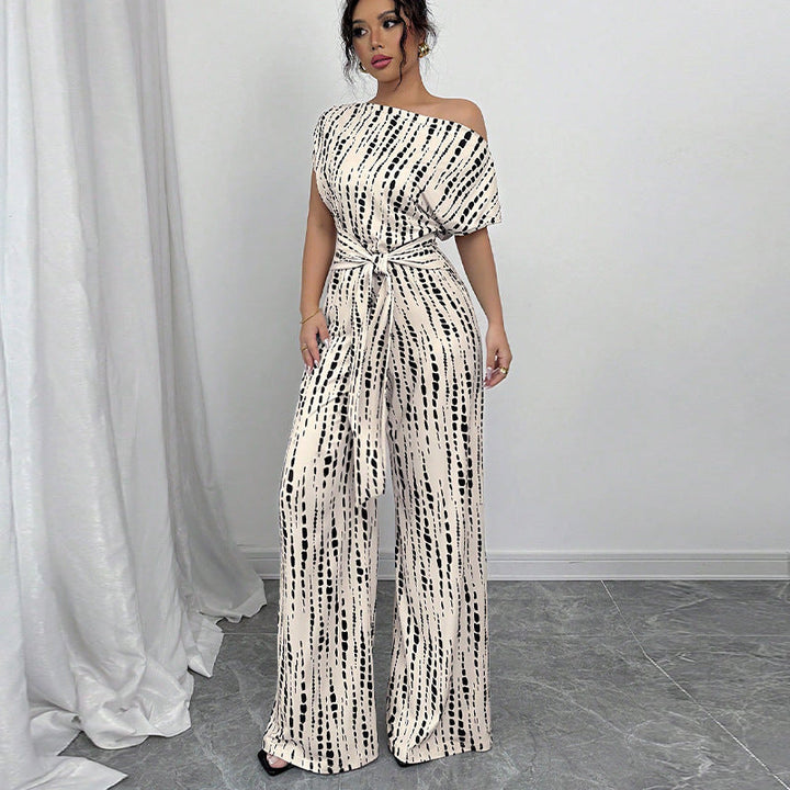 Elegant women's one-shoulder printed wide-leg jumpsuit with belt, perfect for party wear & summer occasions.