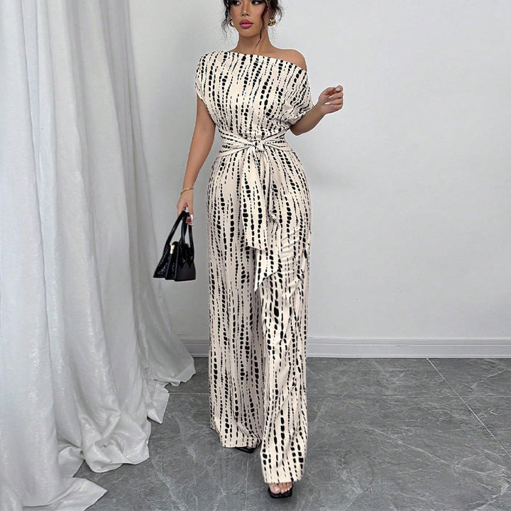 Chic women's printed one-shoulder jumpsuit with wide legs & a belted waist, ideal for elegant party or occasion wear.