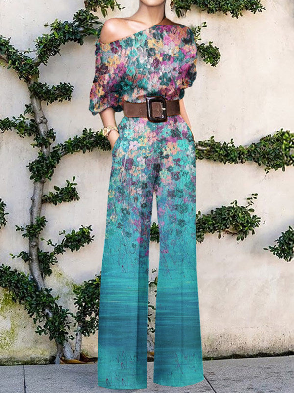 Full-length view of a women's one-shoulder printed wide-leg jumpsuit, showcasing its elegant flow and vibrant print.
