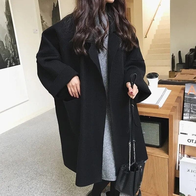 Chic oversized women's trench coat for stylish layering. Elegant and classic business casual outerwear.