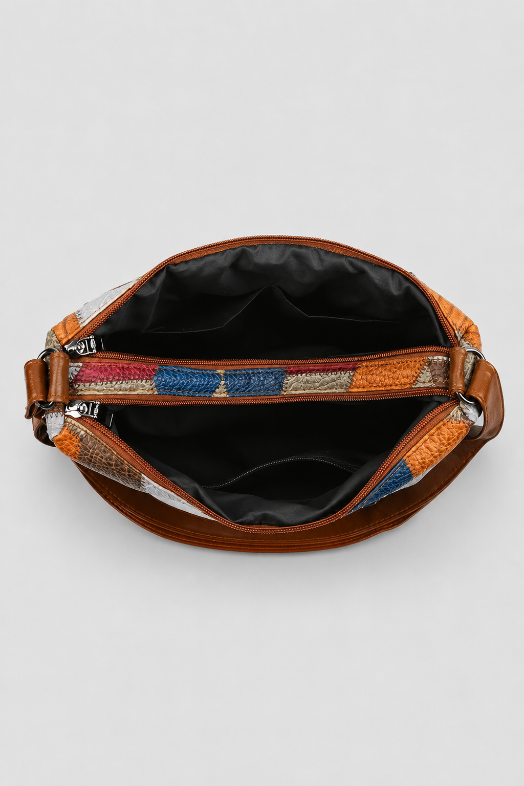Detail view of an elegant women's patchwork shoulder bag, showcasing intricate artistic design and unique patterns.