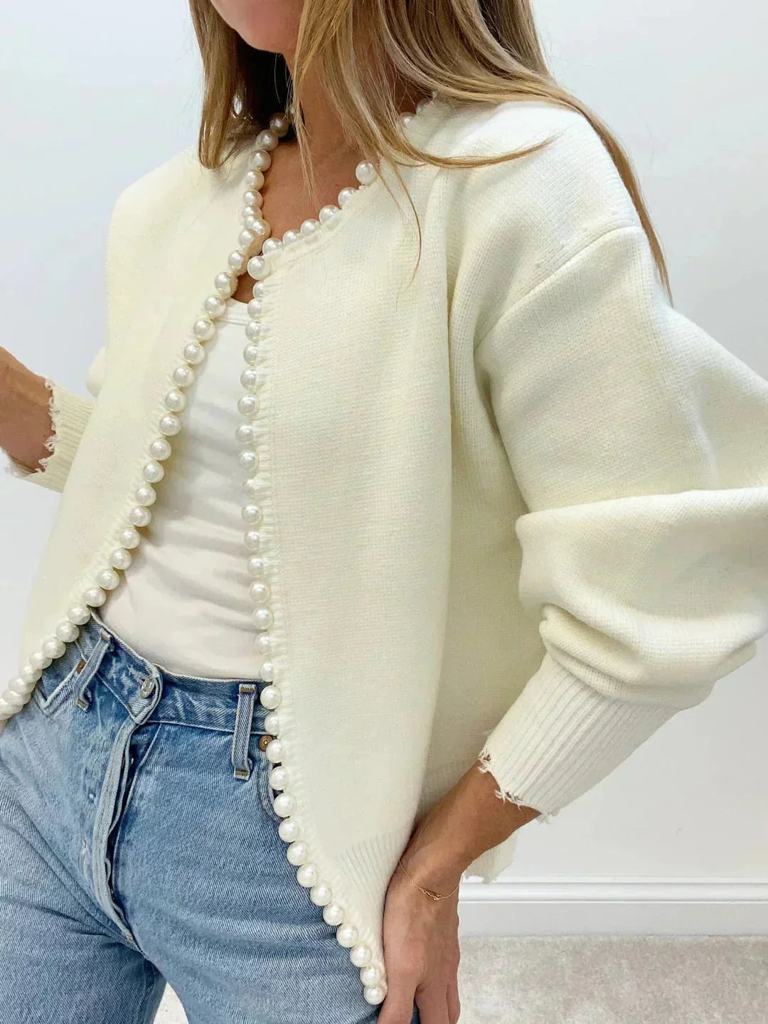 Elegant women's pearl trim knit cardigan with a round neck & long sleeves. Perfect for chic layering.