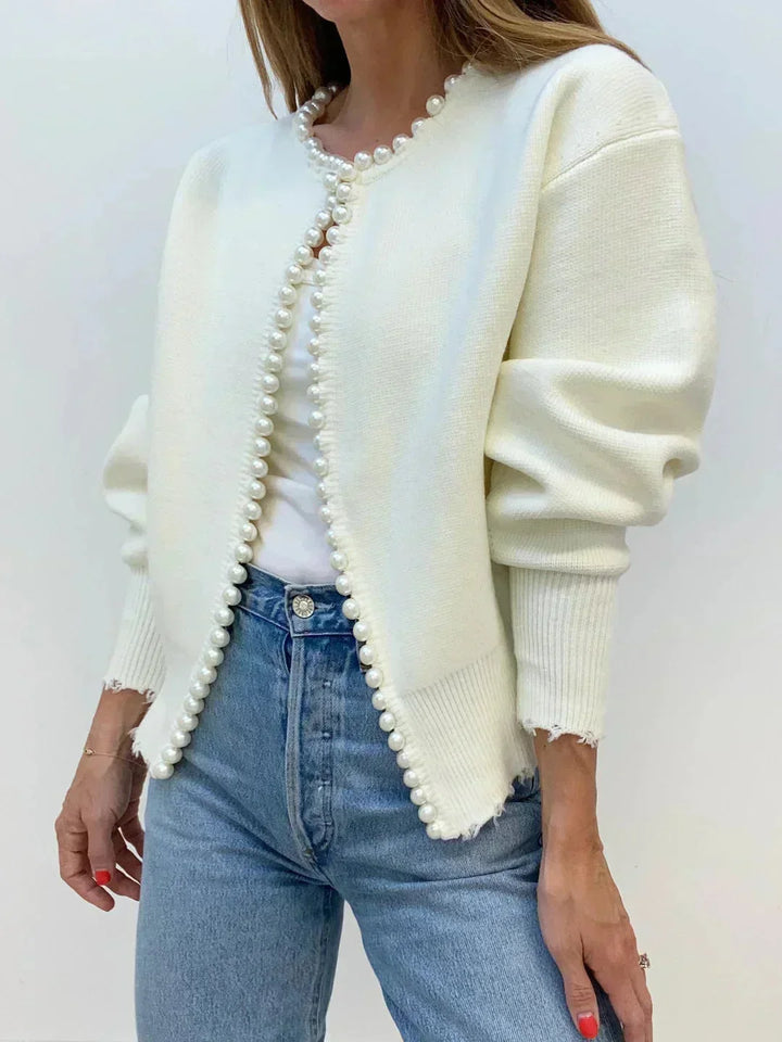 Sophisticated women's knit cardigan featuring delicate pearl trim. Versatile for workwear or elegant brunch.