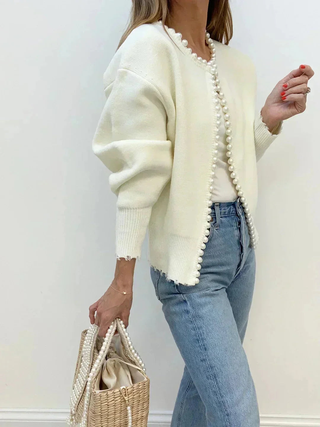 Feminine long-sleeve knit cardigan for women, adorned with stylish pearl trim. Comfortable & chic.