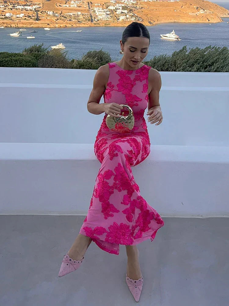 Back view of a stylish women's pink floral high-neck maxi dress. An elegant formal evening gown perfect for wedding guests.