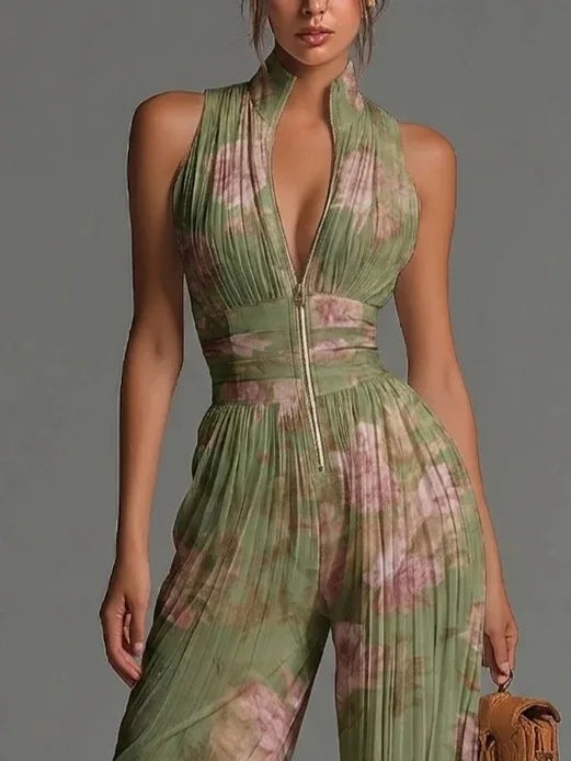 Flowy women's halter neck jumpsuit with elegant floral pattern & pleats, wide-leg design for vacation wear.