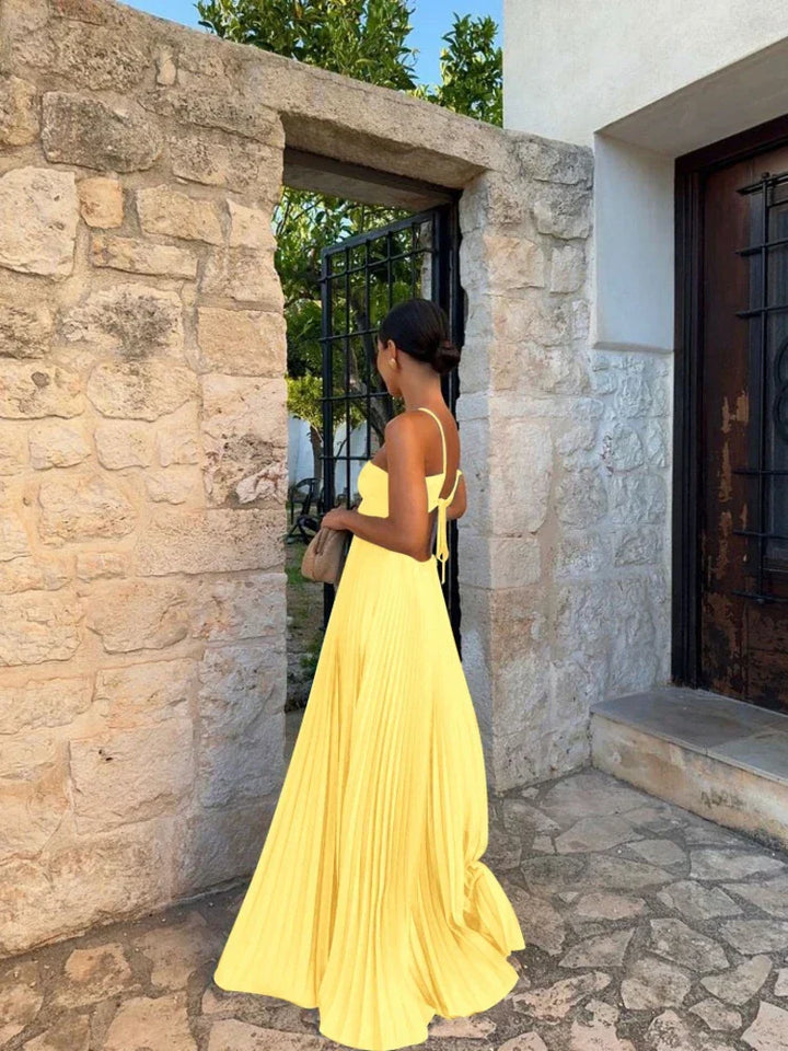 Beautiful women's wedding guest dress: a sleeveless pleated halter maxi gown for formal events.
