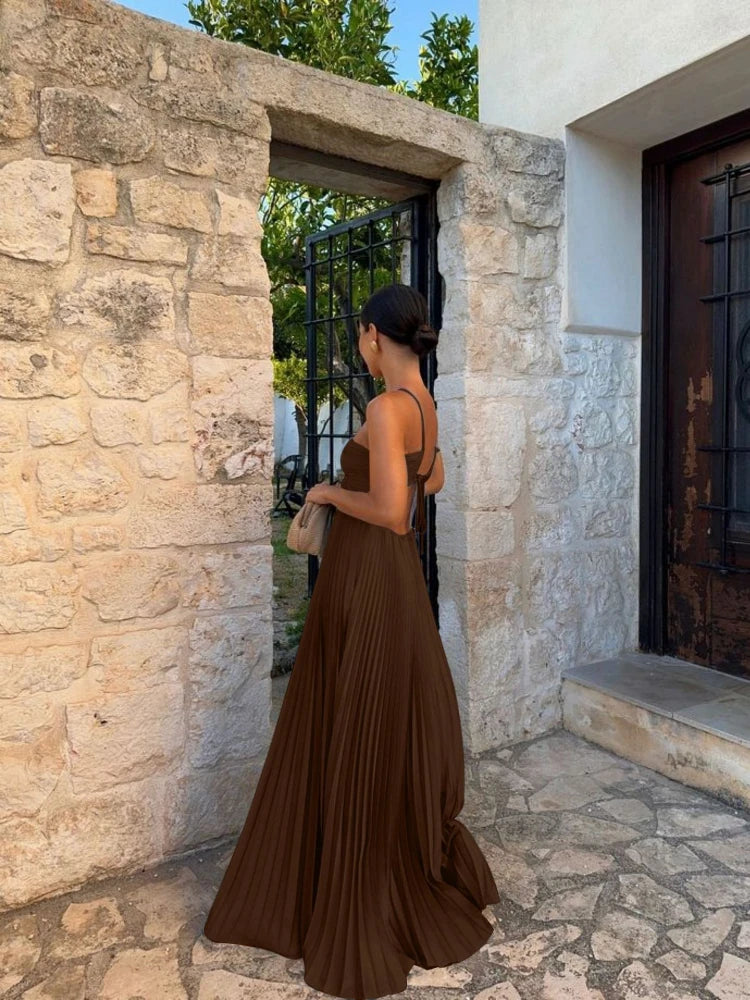 Women's elegant evening party dress, featuring a pleated maxi skirt and chic halter neckline.