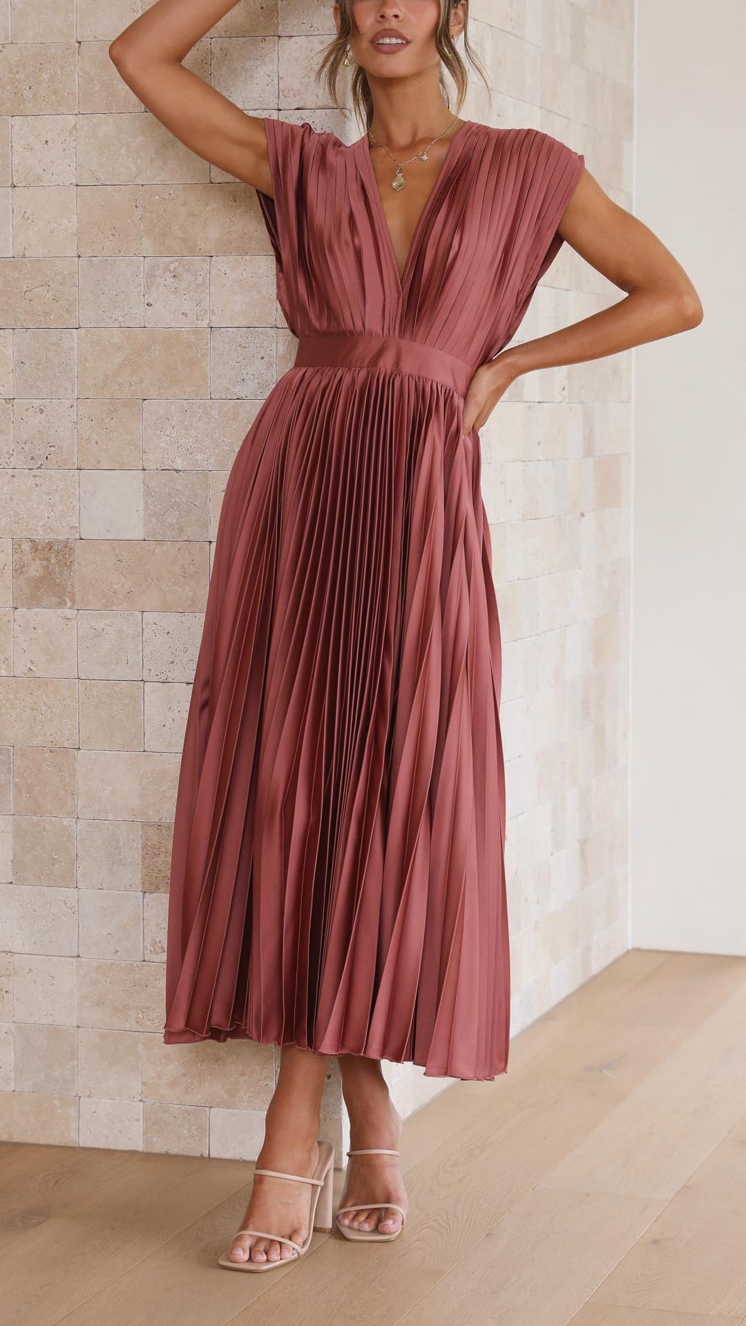 Sophisticated long pleated gown, sleeveless & V-neck, ideal as a wedding guest or cocktail dress.